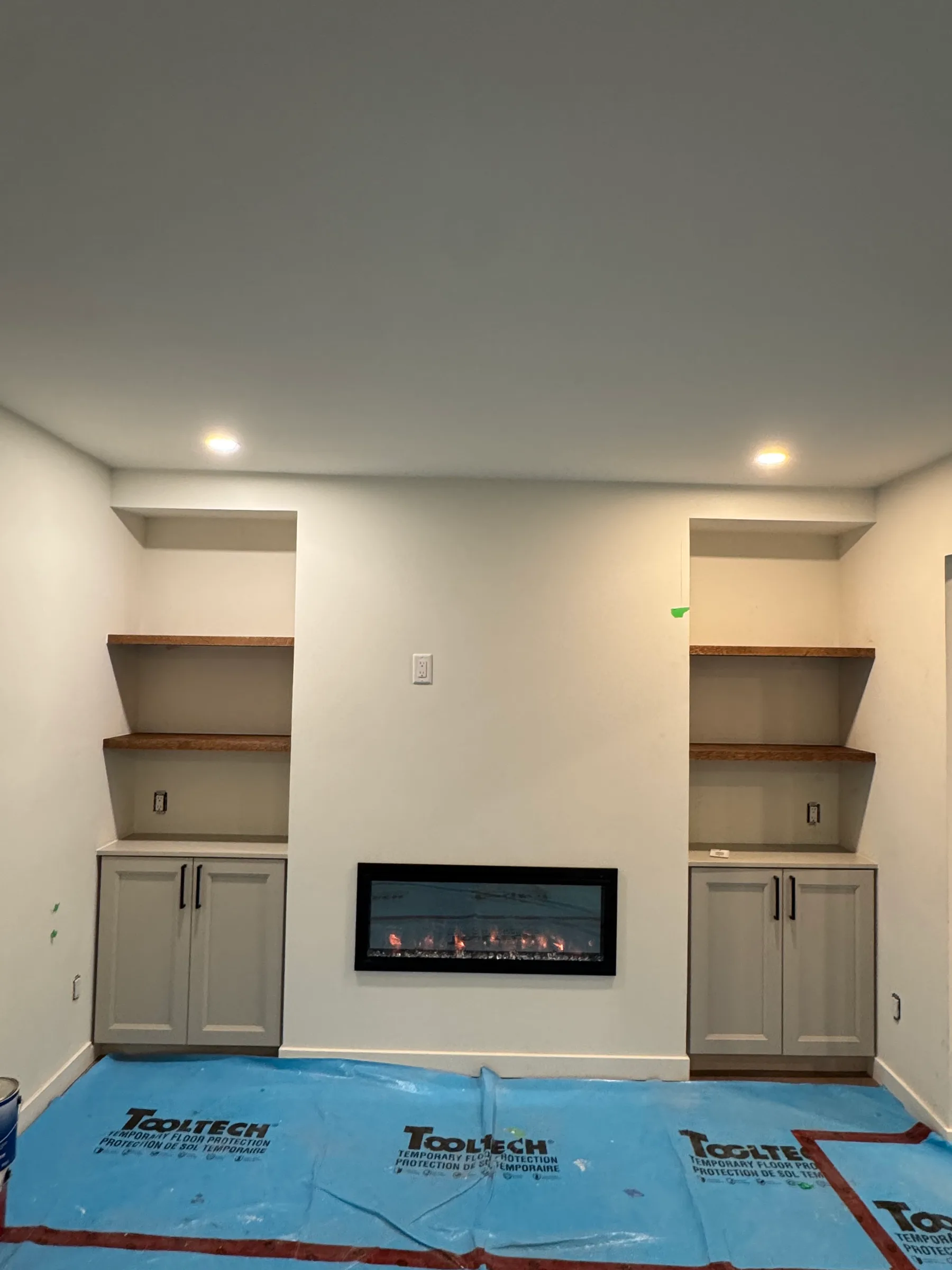 Built-in fireplace feature wall with custom shelving and base cabinets, Ottawa